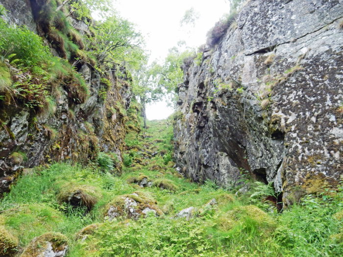 The upper part of one of three chasms carved by melt-water into the down-valley slopes of the ridge NW of Craig Nordie at the extreme NE of the Glen Feardar map.   This particular narrow gorge leads down into a surprisingly large, deeply incised feature, once full of rushing water and now littered with tumbled granite boulders.